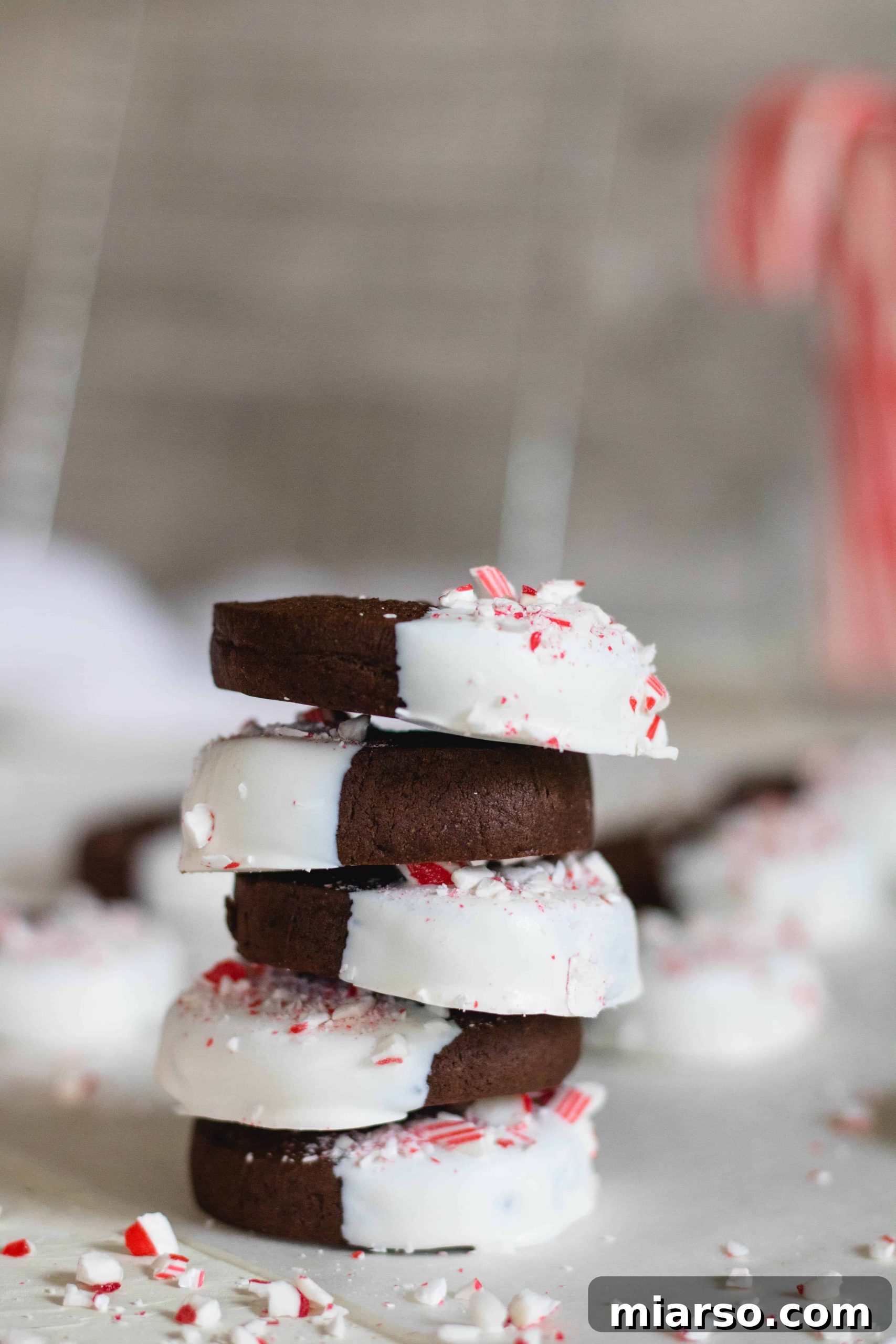 Gourmet Chocolate Peppermint Crunch Logs 12 A stack of chocolate peppermint crunch slice and bake cookies on a rustic wooden board