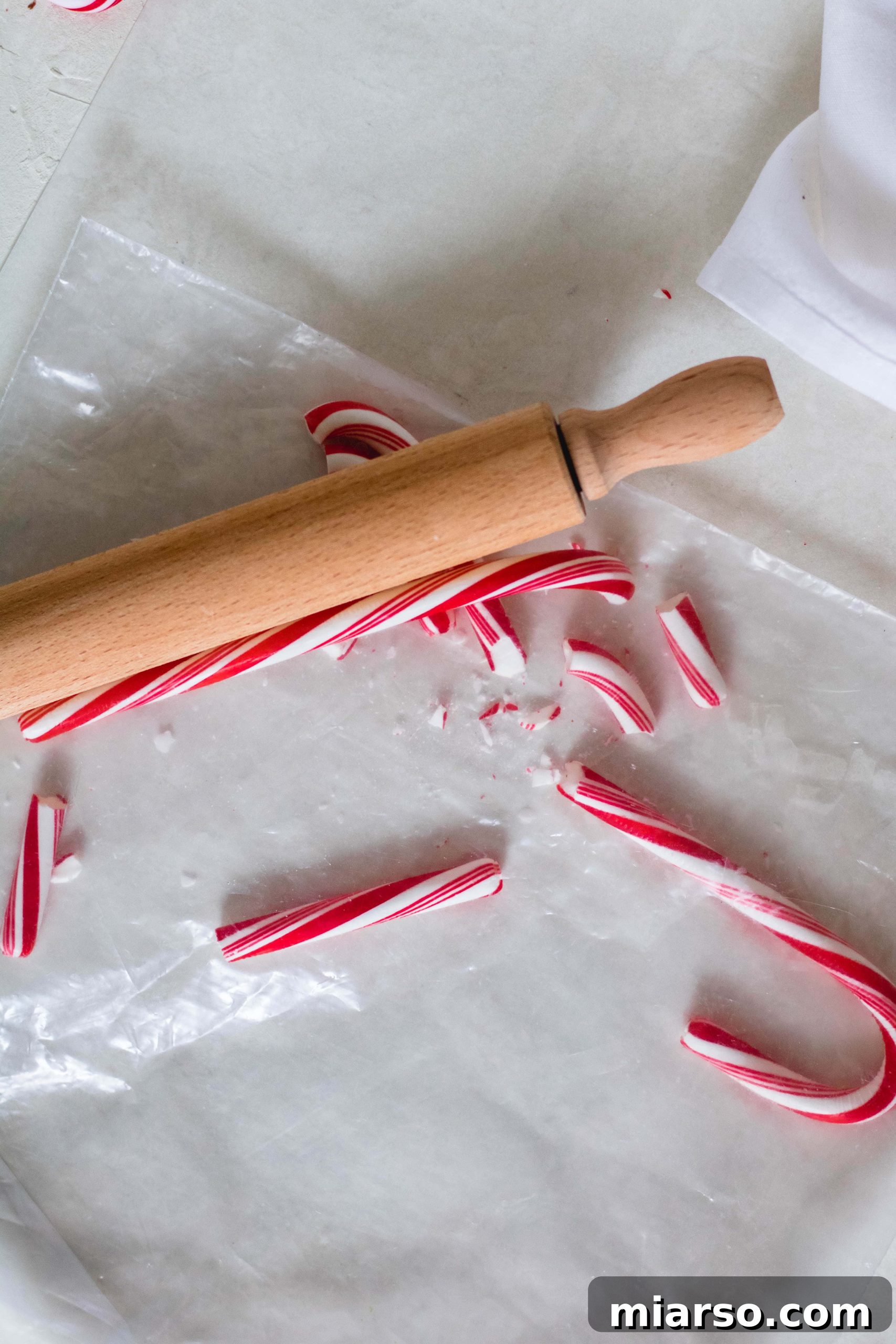 Gourmet Chocolate Peppermint Crunch Logs 9 Candy canes being crushed into small pieces for cookie topping