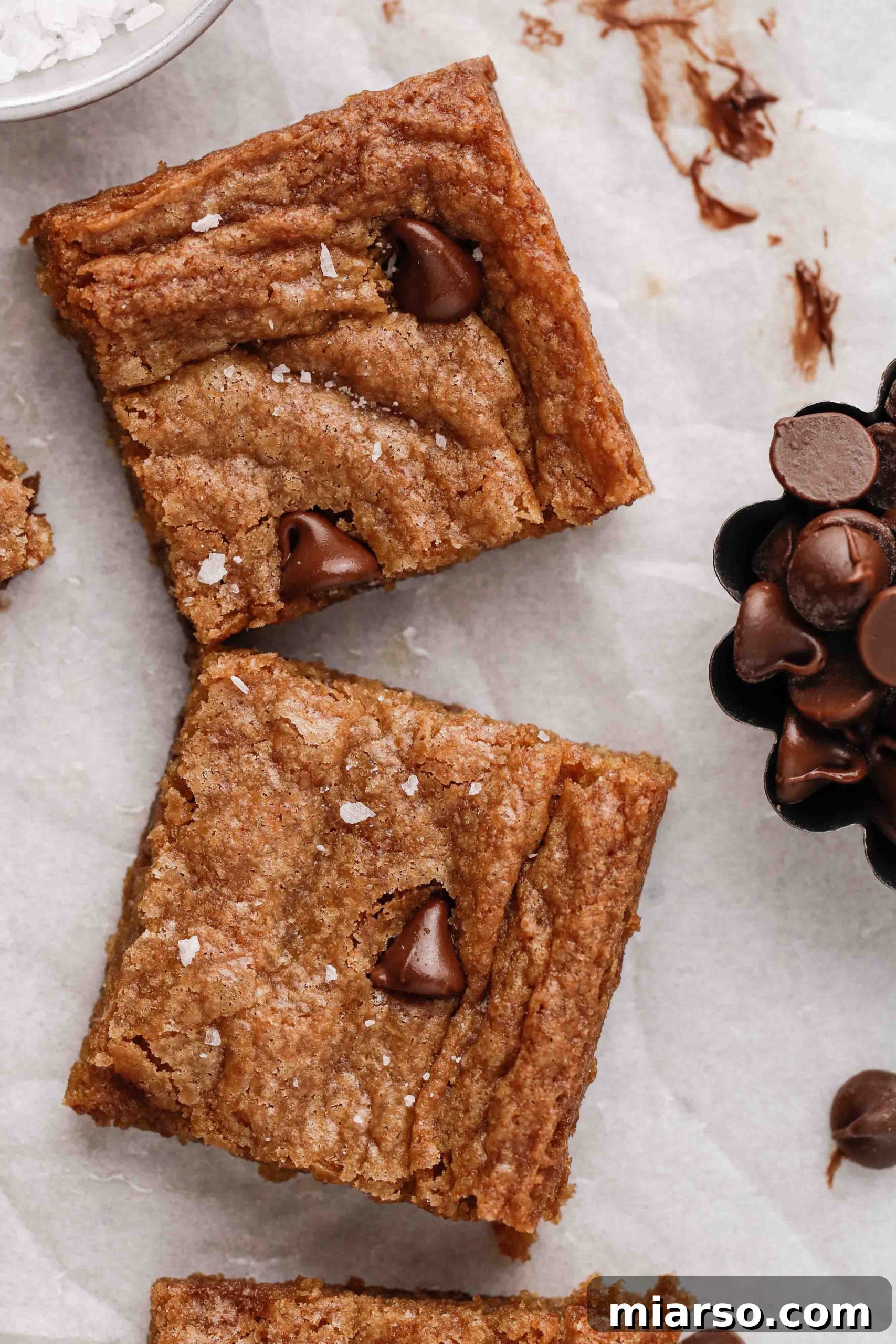 Sweet Tomatoes' Homestyle Chocolate Chip Bars 7 A close-up view of freshly baked chocolate chip cookie bars, revealing their soft, gooey texture and melted chocolate
