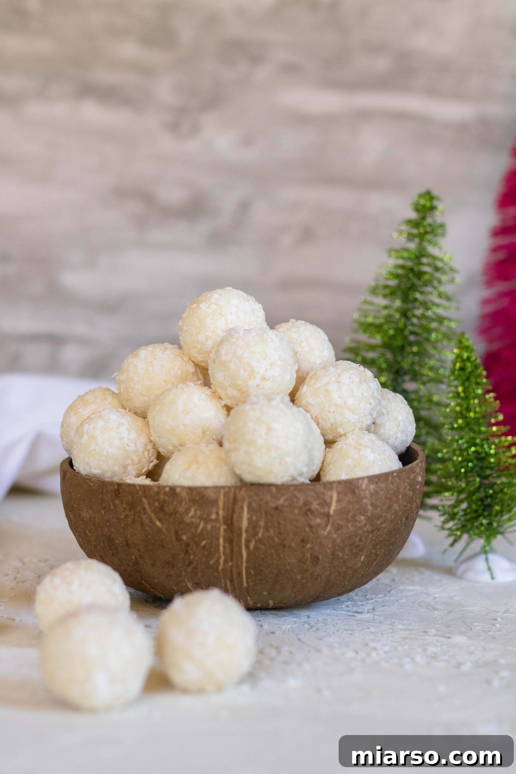 Delicious 2-ingredient no bake coconut truffles in a coconut bowl