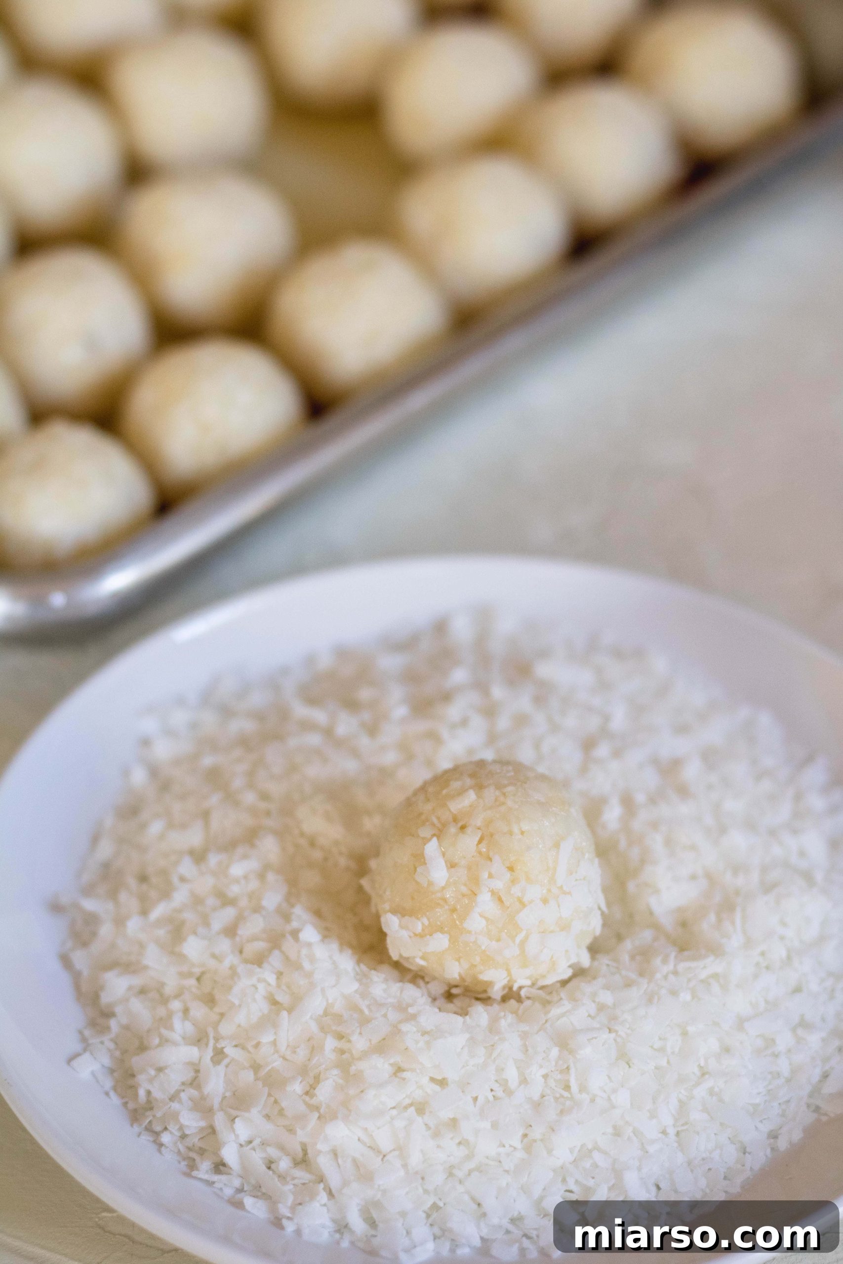Perfectly coated no bake coconut balls made with condensed milk