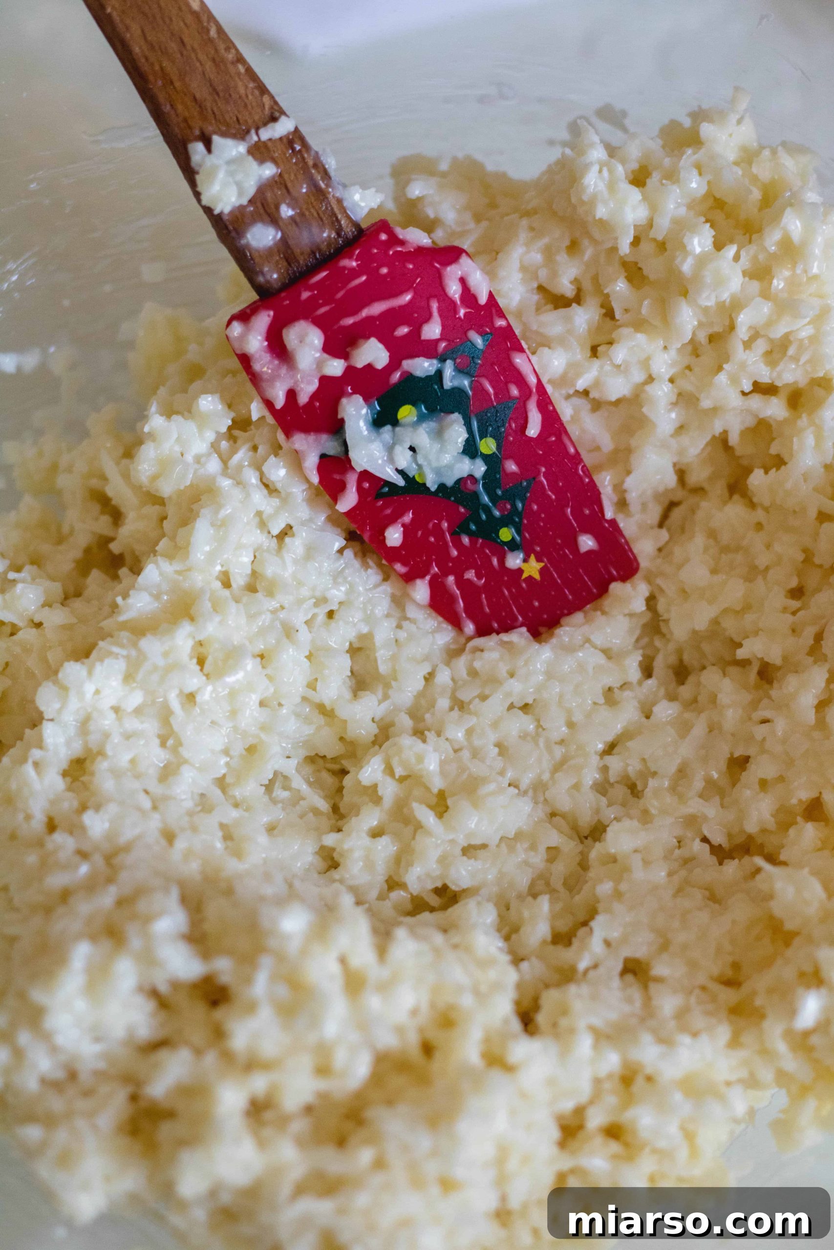 Mixing coconut and condensed milk for no bake coconut balls