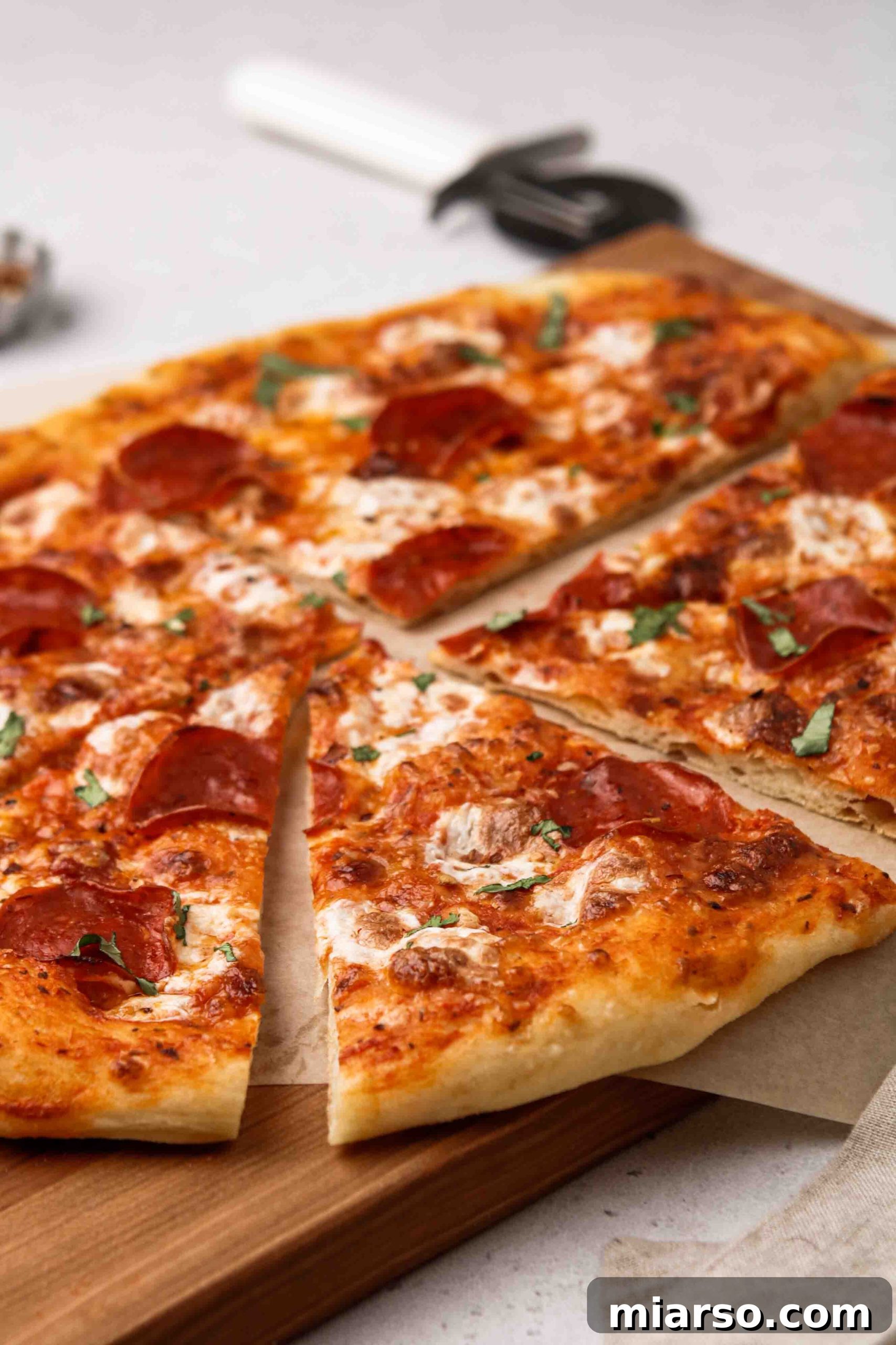 Easy and delicious pizza dough recipe, featuring a pizza fresh out of the oven, cut into slices.