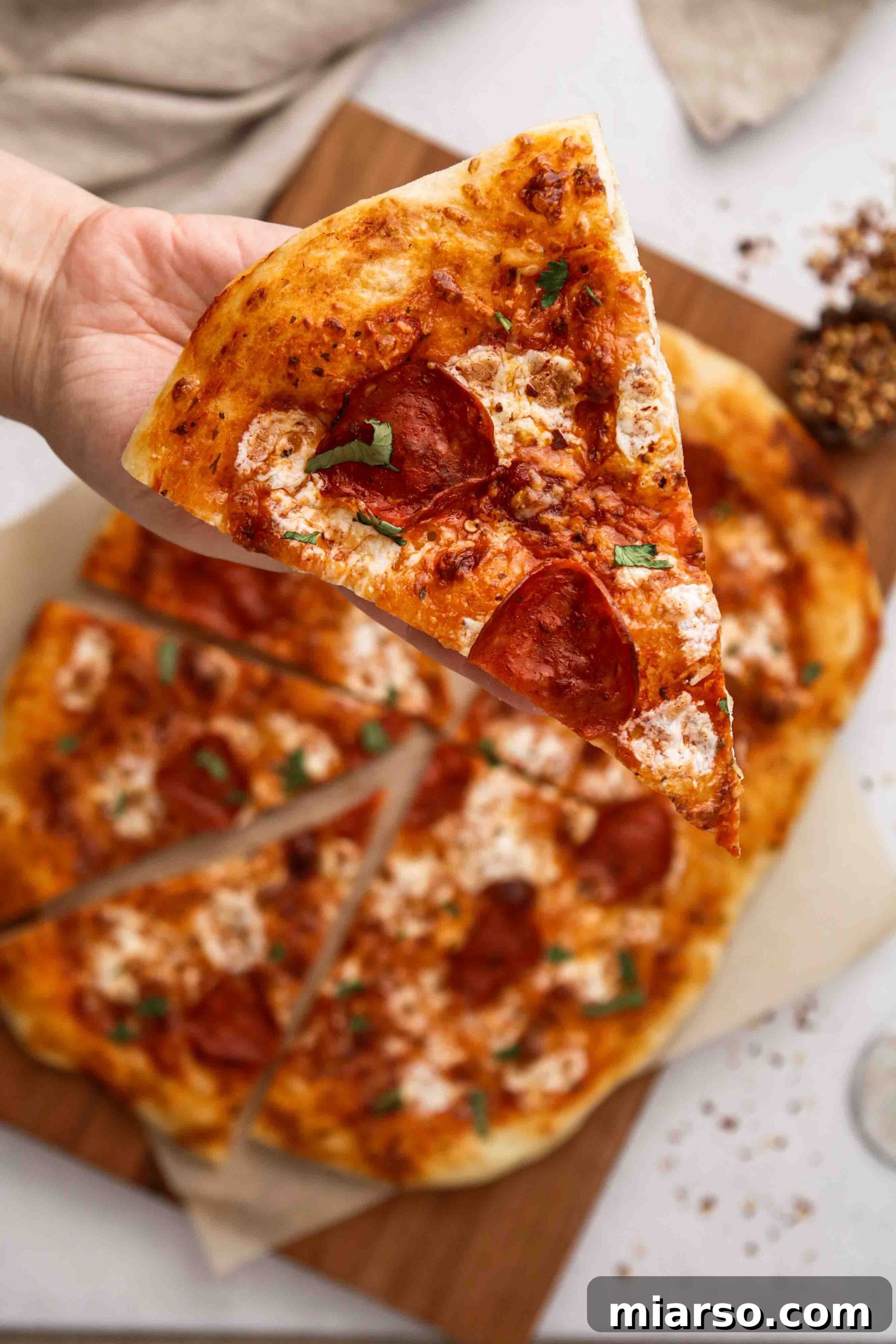 Pepperoni pizza made with easy no-knead pizza crust, loaded with melted cheese and vibrant toppings.