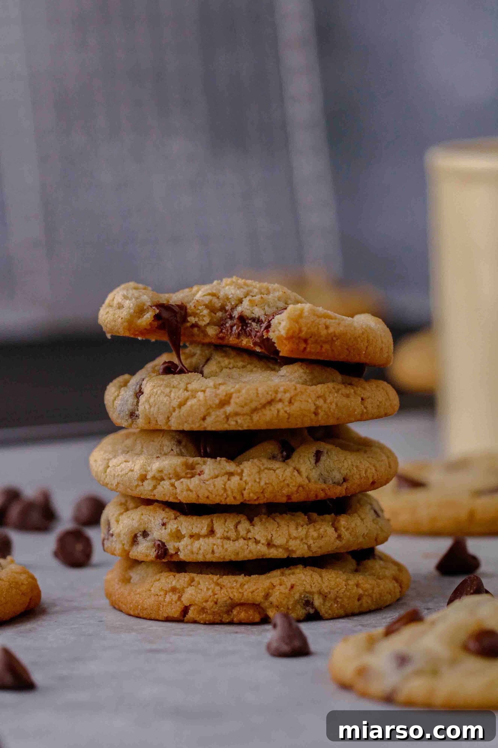 Almond flour chocolate chip cookie stack, showing soft texture and melted chocolate chips.