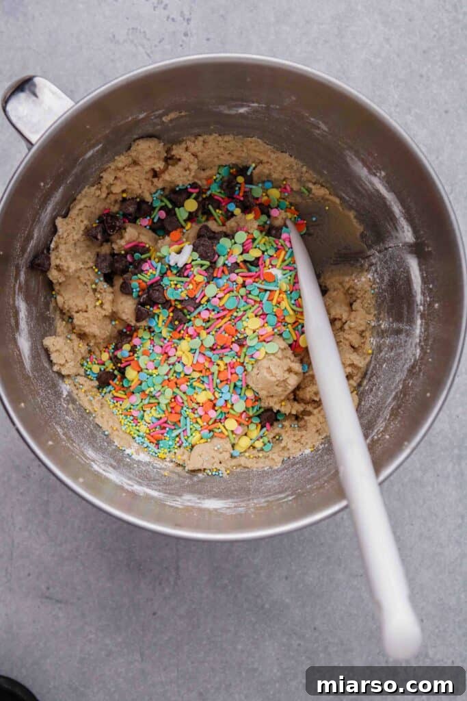 Fold in the chocolate chips and sprinkles into the cookie dough