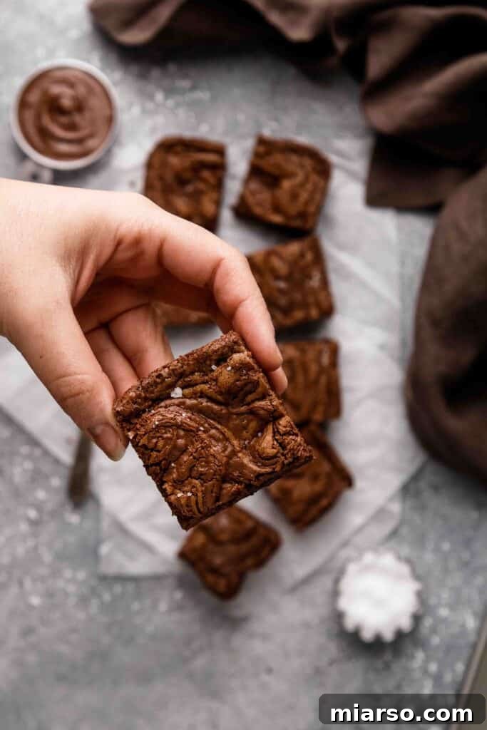 Hand holding Nutella brownie slice