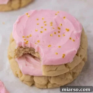 Stack of Crumbl sugar cookies with pink frosting