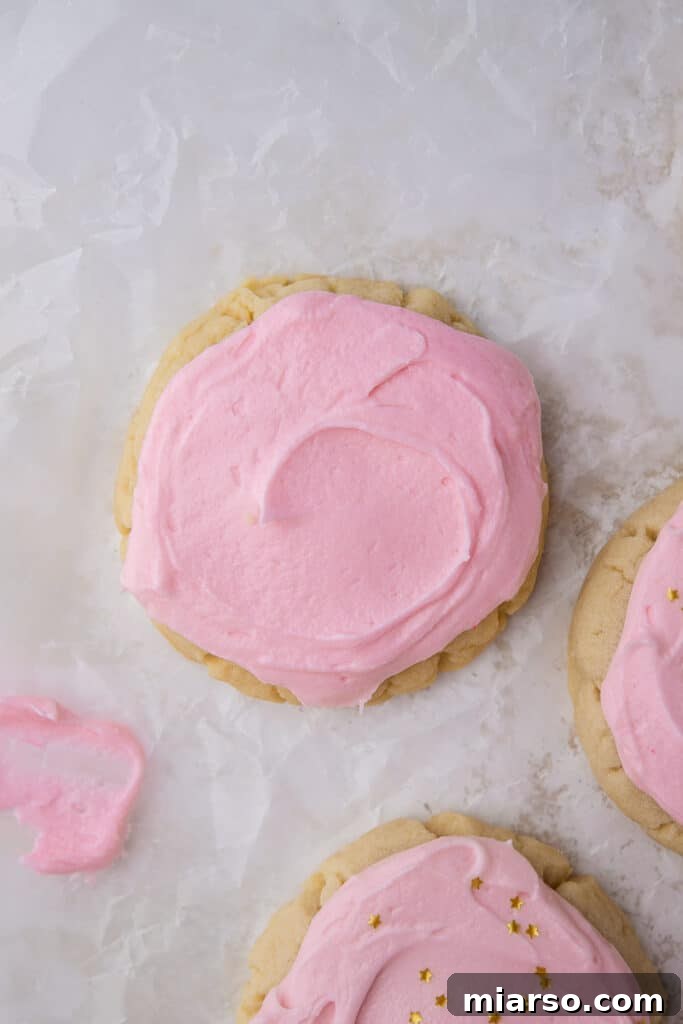 Two soft and thick Crumbl sugar cookie copycats on a plate