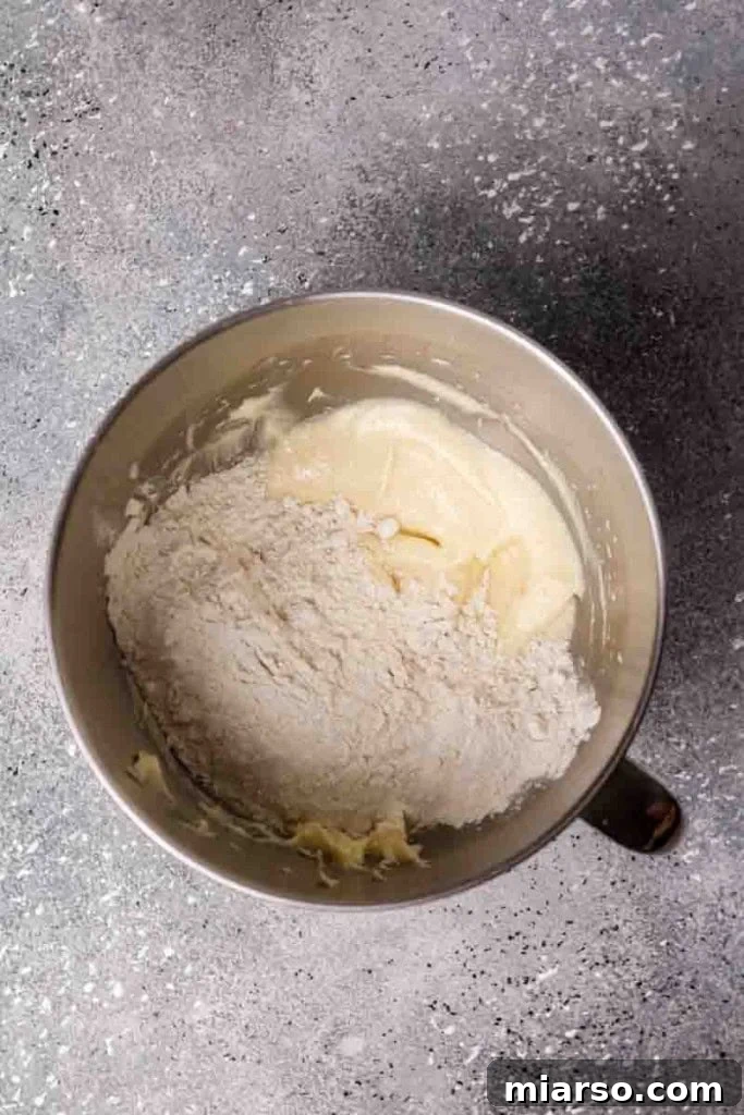 Adding dry ingredients to the butter and sugar mixture