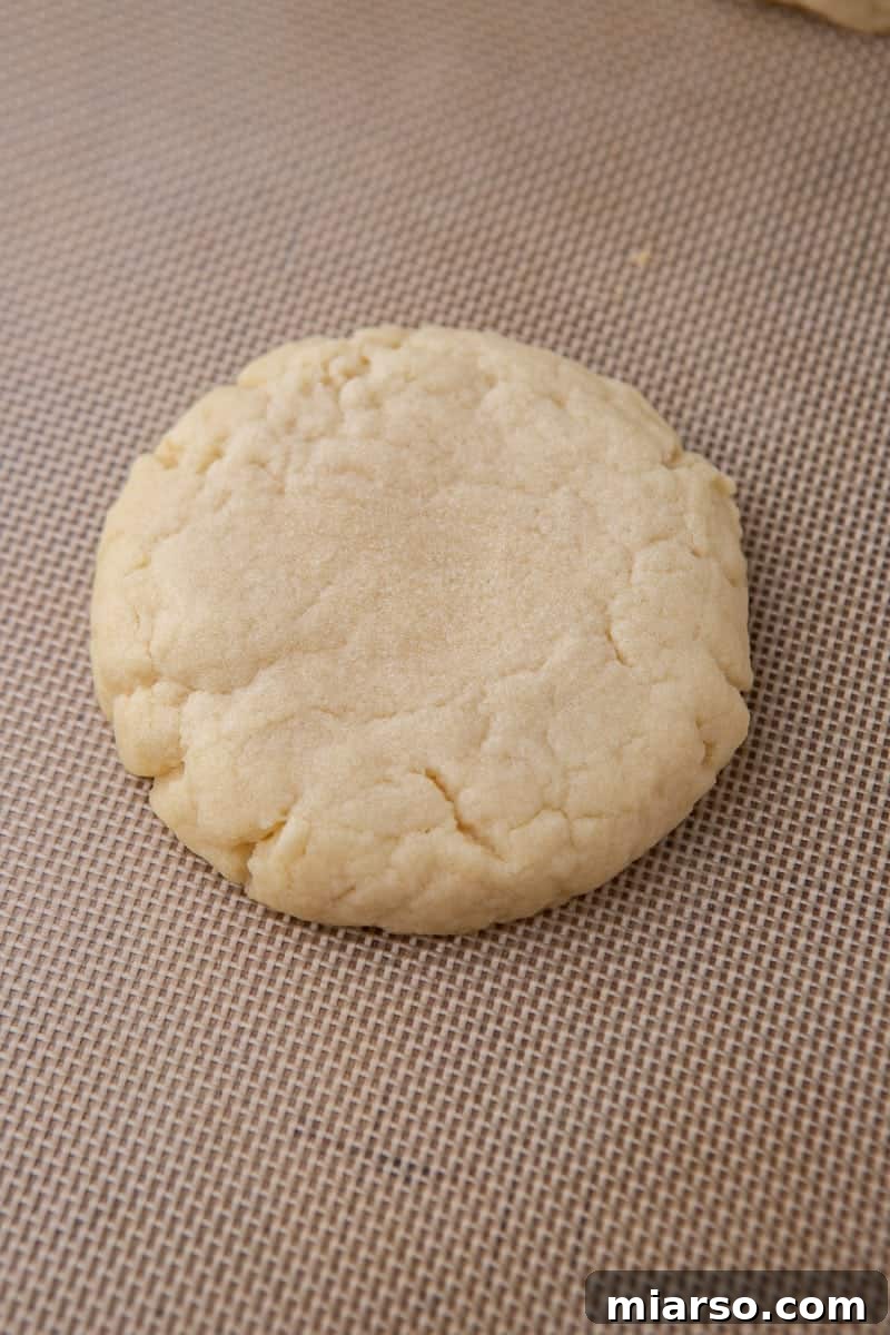 Baked, pale Crumbl sugar cookie on a baking sheet