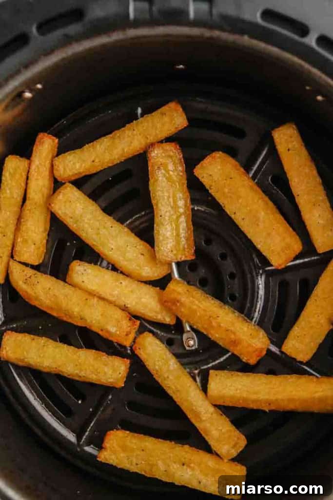 Beautifully crispy, golden brown air-fried polenta fries, fresh out of the air fryer
