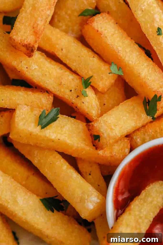Close-up shot of golden brown, perfectly cooked Air Fryer Polenta Fries, highlighting their crispy texture