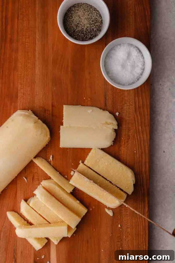 A close-up of uniformly cut polenta fries, ready for seasoning and air frying