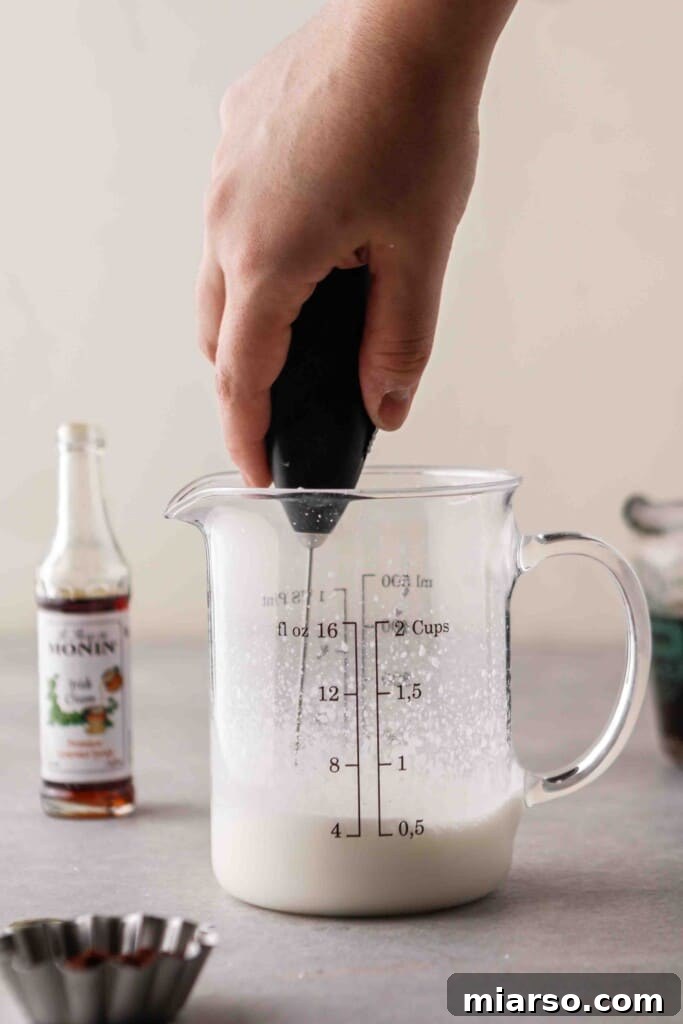 Froth vanilla sweet cream with a hand held frother