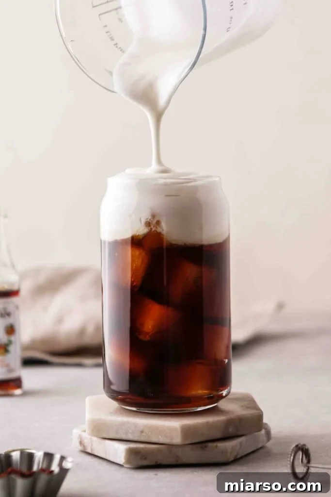Top the cold brew coffee with vanilla sweet cream 