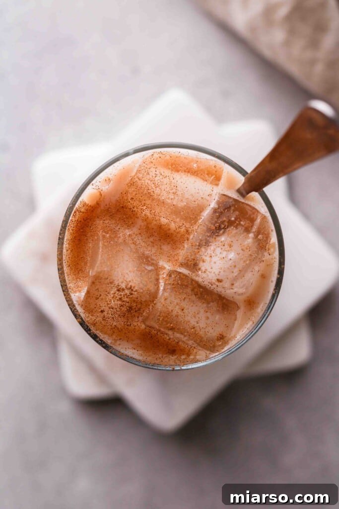 Overhead shot of iced chai latte in a glass with ice