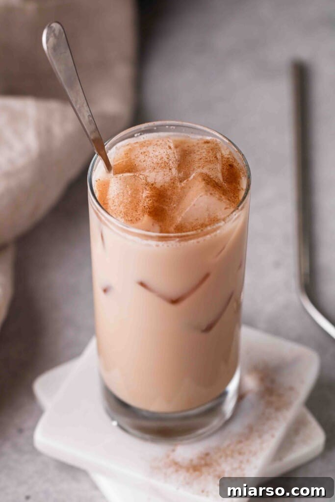 A glass of Starbucks iced chai tea latte on a coaster