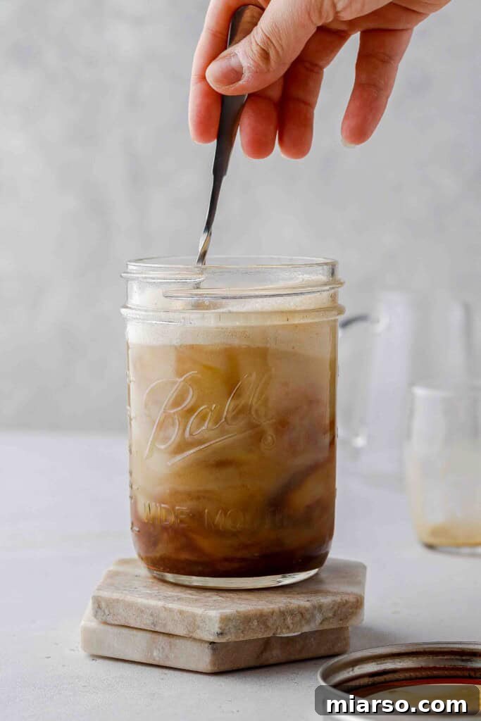 Golden Oat Shaken Espresso 11 Stirring the completed shaken oat milk espresso