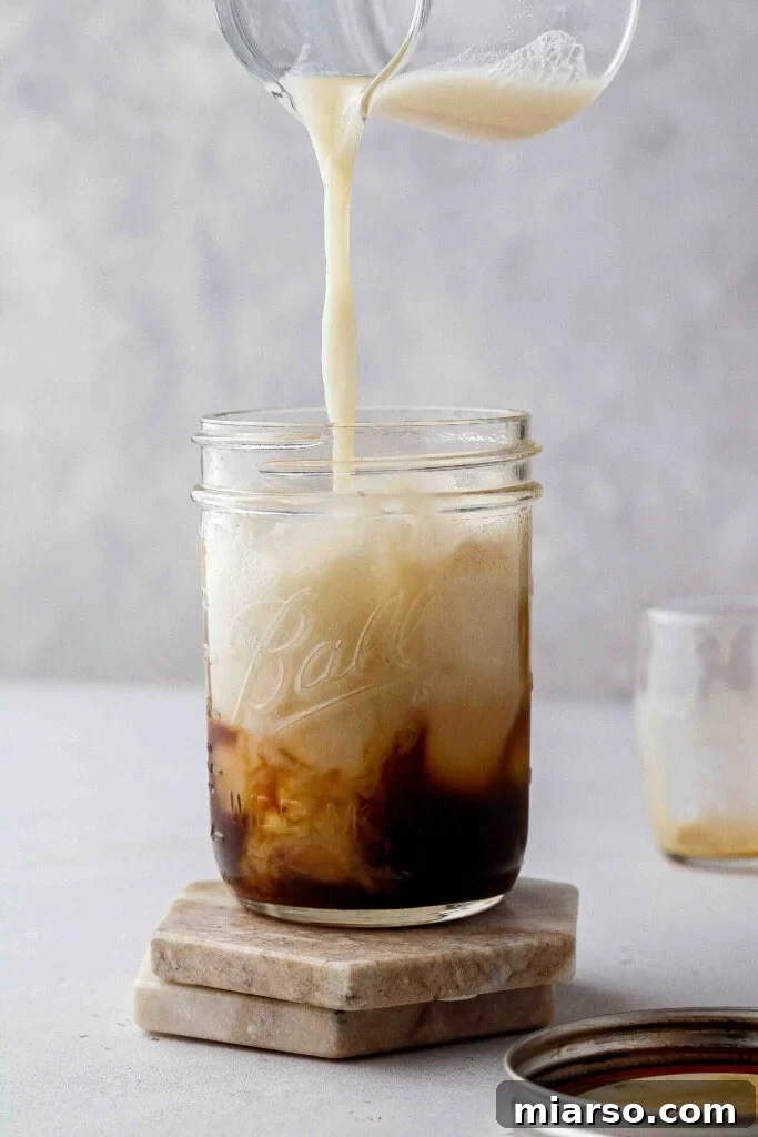 Golden Oat Shaken Espresso 3 Close-up of Starbucks Iced Brown Sugar Oatmilk Shaken Espresso with ice and foam