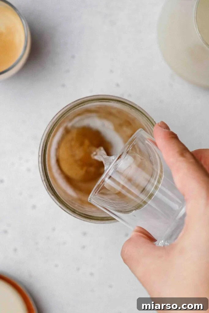 Golden Oat Shaken Espresso 6 Adding brown sugar and cinnamon to a mason jar