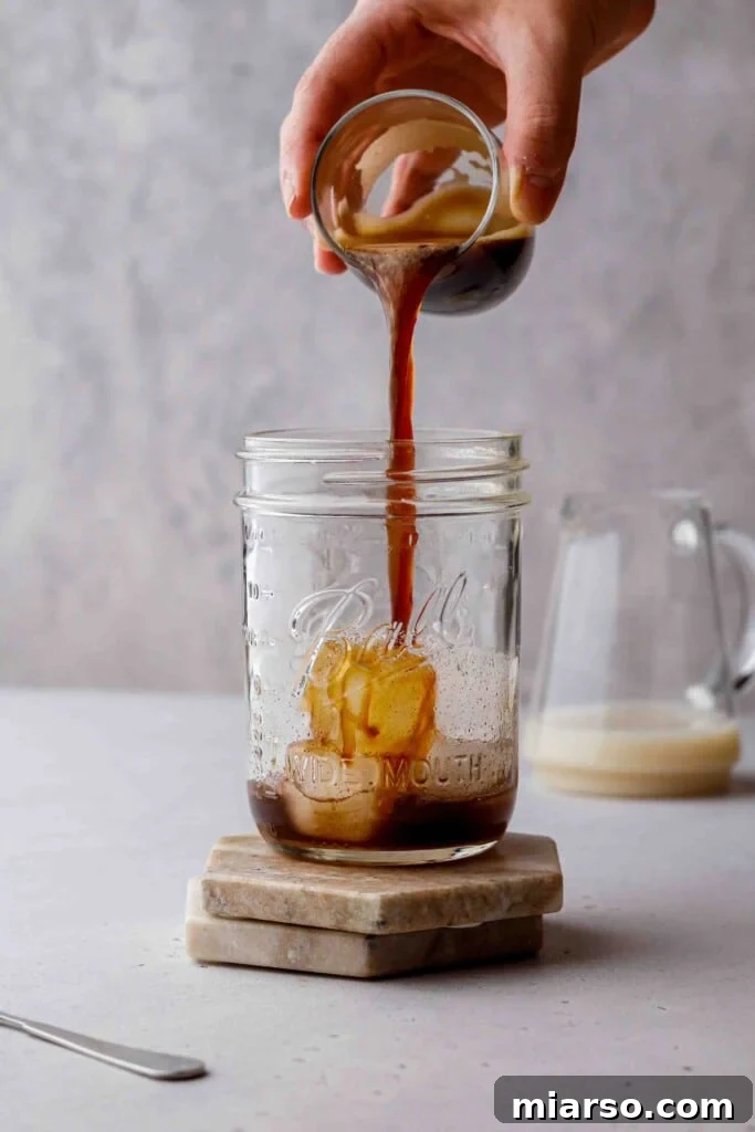 Golden Oat Shaken Espresso 8 Pouring espresso over ice and brown sugar syrup
