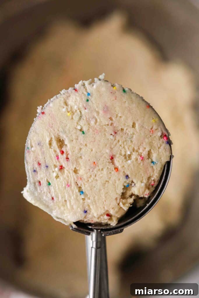 Cookie dough scooped into a large cookie scoop, ready for baking