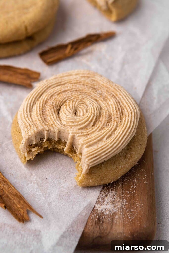 Irresistible Crumbl Churro Sugar Cookie with a bite taken out, showcasing its soft interior and generous cinnamon-sugar coating.