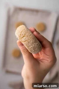 Hand showing thickness of cookie before baking