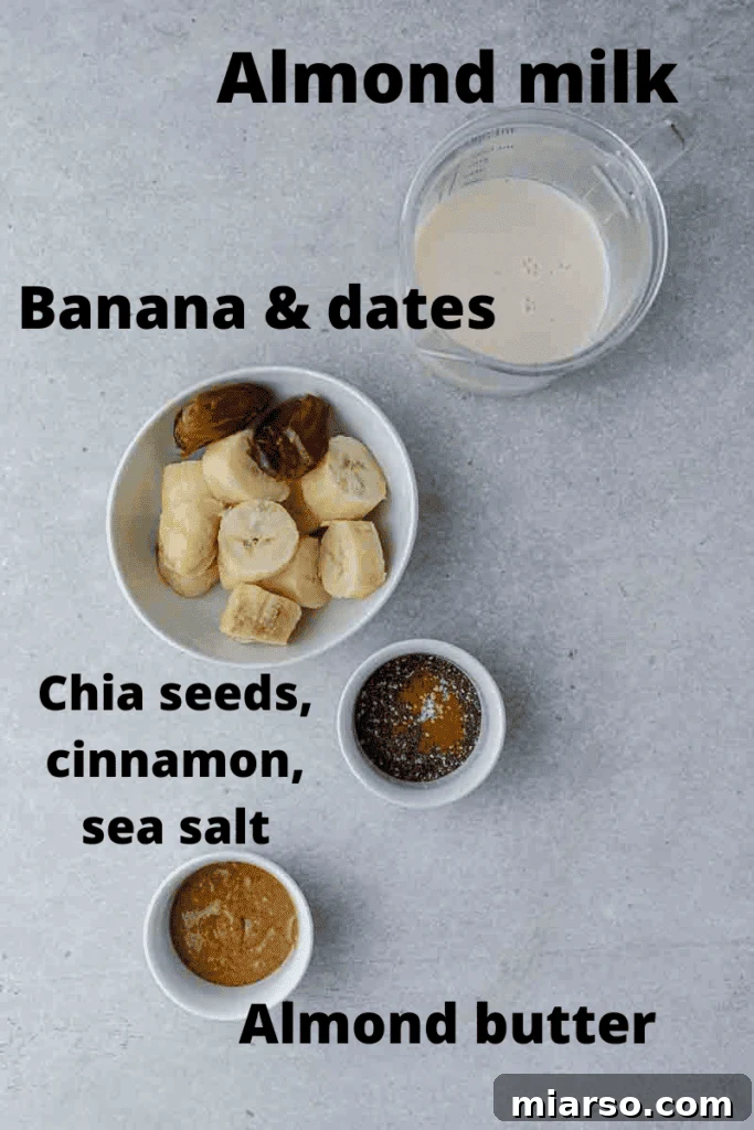 Ingredients for a date smoothie laid out on a table: bananas, dates, almond butter, milk, chia seeds, cinnamon, and salt