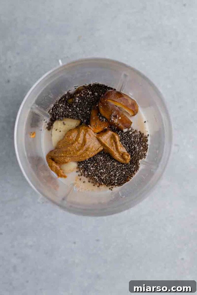 All smoothie ingredients placed inside a blender before mixing