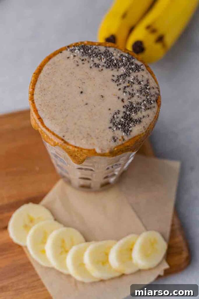 Blended almond banana date smoothie spinning in a high-speed blender