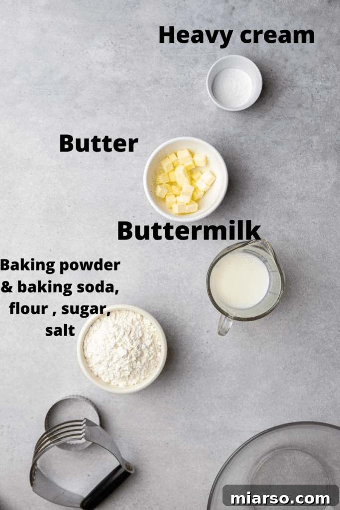 Essential ingredients laid out for making small-batch buttermilk biscuits: flour, butter, buttermilk, leavening agents, and sugar.