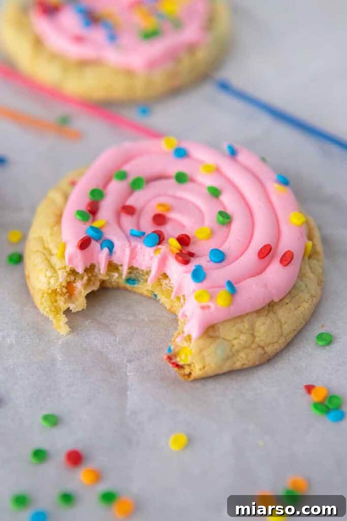 CRUMBL confetti cake cookies with pink frosting and sprinkles