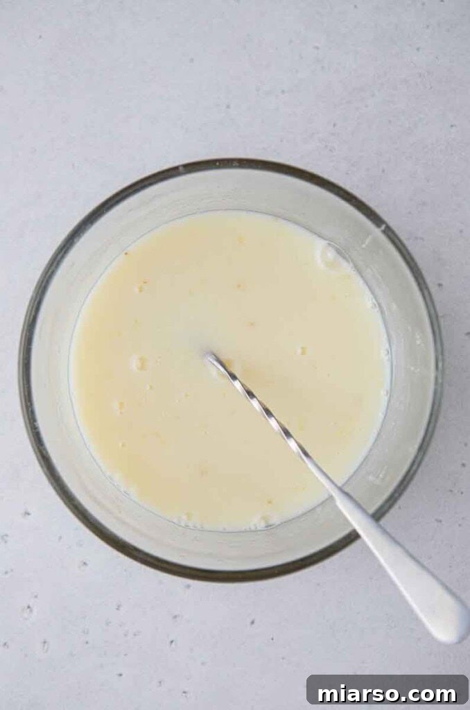 Mixing lemon juice with sweetened condensed milk and sugar