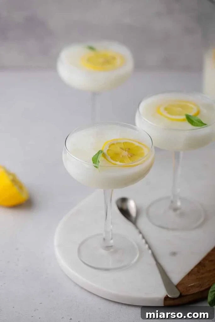 Summer sweetened condensed milk drink in tall glass with lemon slices