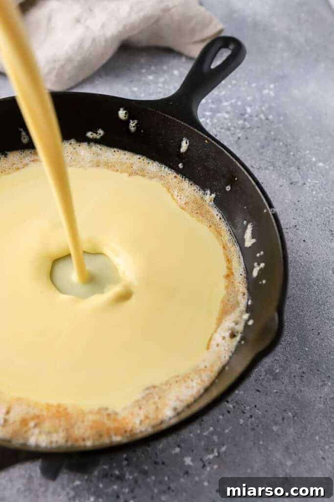 Pancake batter poured into a hot skillet