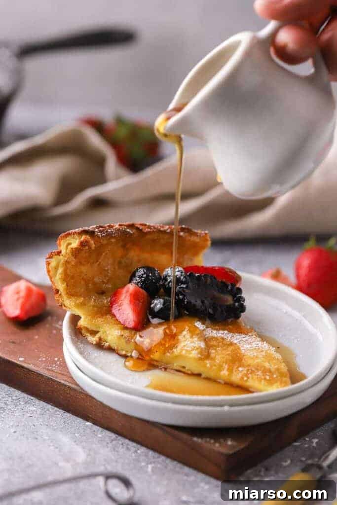 Slice of German pancake topped with fresh berries