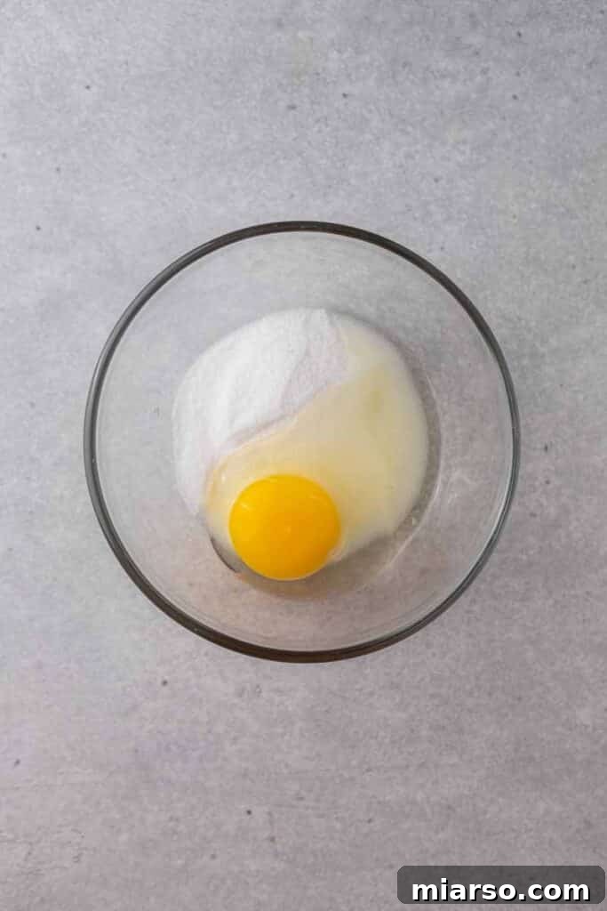 Egg and sugar in mixing bowl