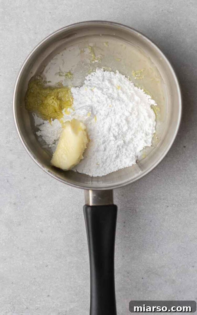 Effortless Crumbl Lemon Glazed Cookies 10 Lemon butter glaze bubbling gently in a small saucepan.