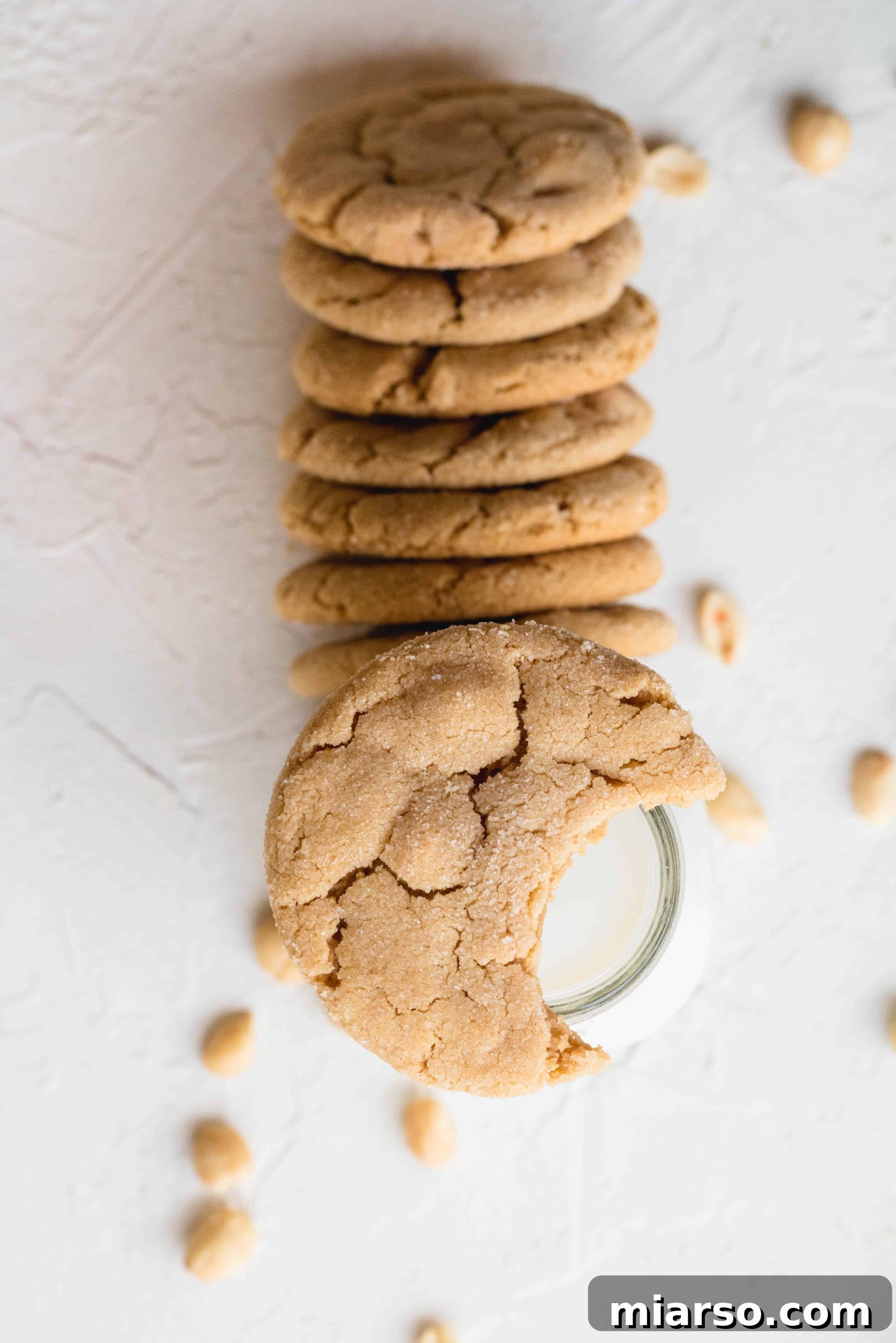Small batch soft peanut butter cookies arranged in a row on a white surface