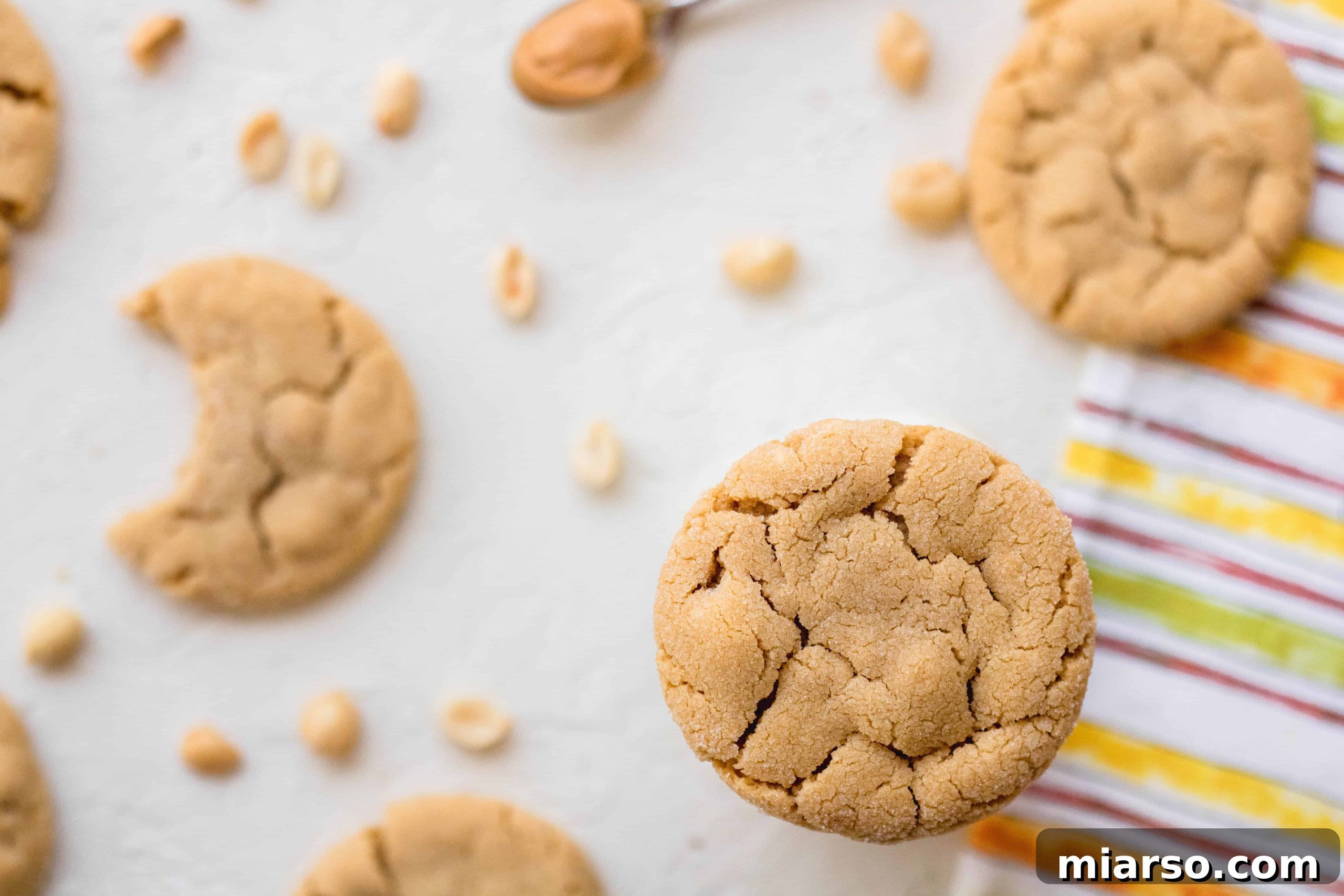 Close-up of a perfectly baked, soft and chewy small batch peanut butter cookie, showing its texture