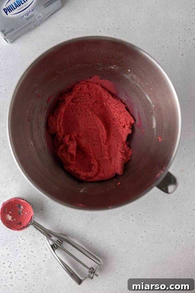 Pink cookie dough in a mixing bowl