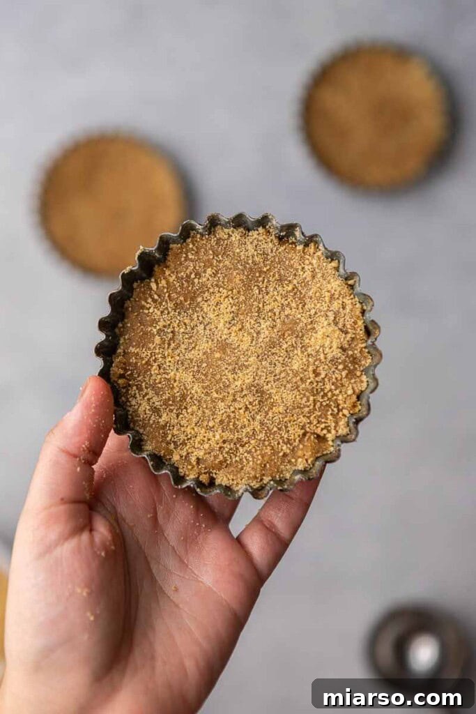 Cookie dough pressed into a tart pan, showing the ideal shape before baking.