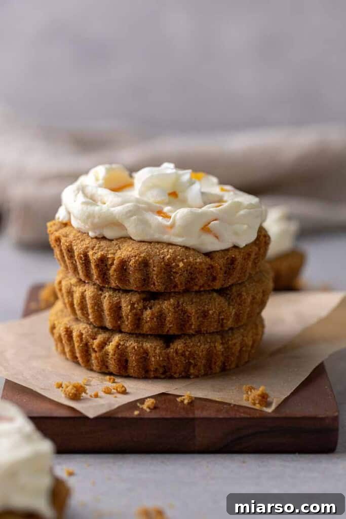 A beautiful stack of CRUMBL peaches and cream cookies, showcasing their inviting texture and rich topping, ready to be served.