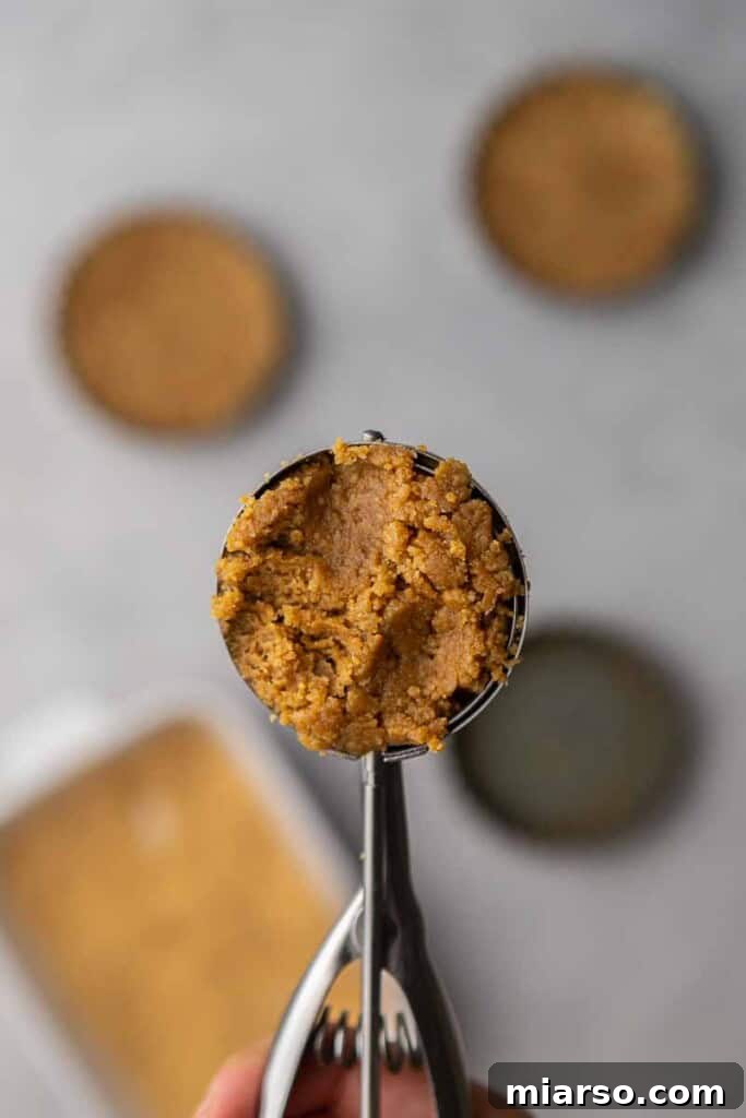 Cookie dough scooped into a large cookie scooper, demonstrating precise portioning for consistent cookie size.