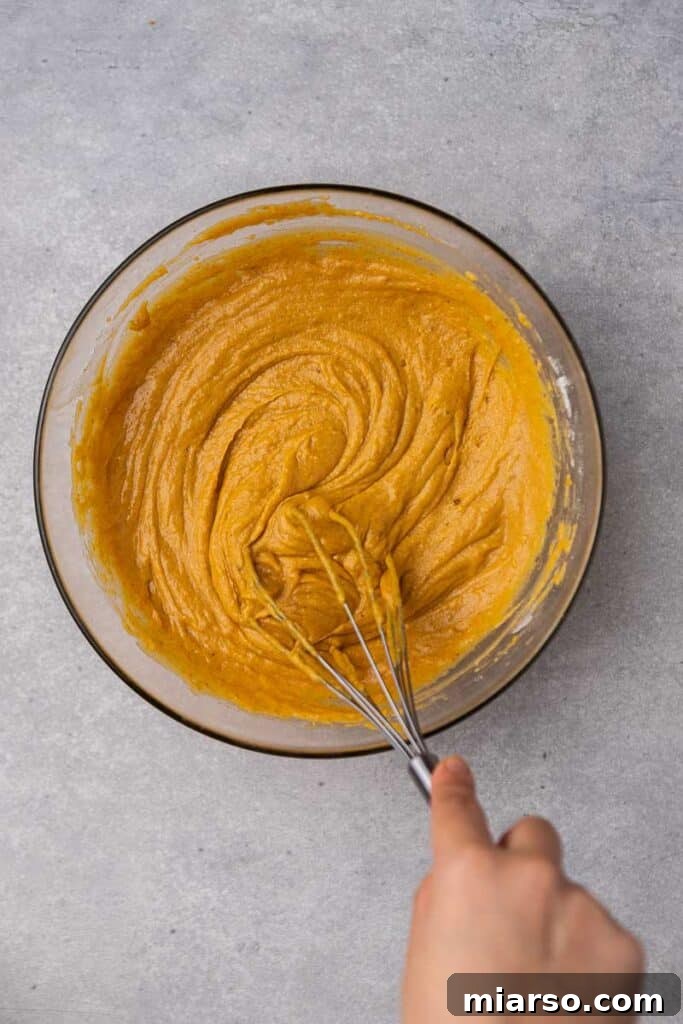 Flour added to wet ingredients for pumpkin bread