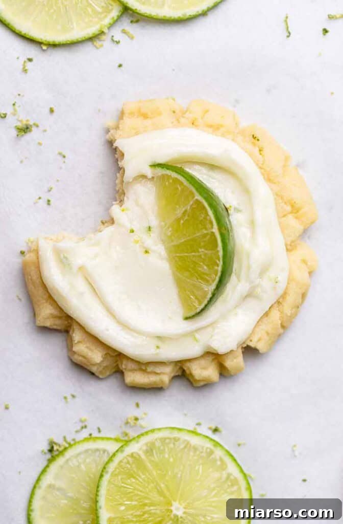A plate of CRUMBL coconut lime cookies garnished with lime slices