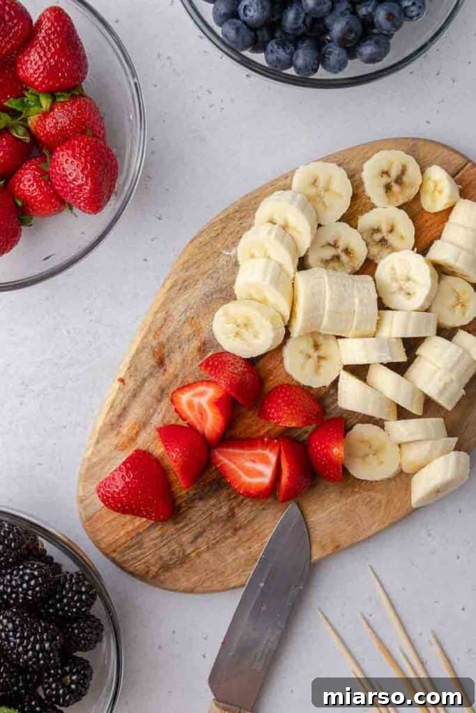 Sliced bananas and strawberries for fruit skewers