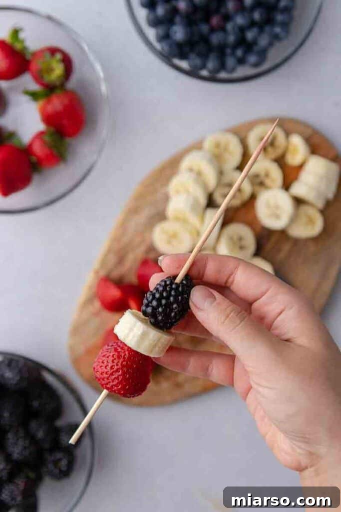 Strawberry, banana, and blackberry on a skewer